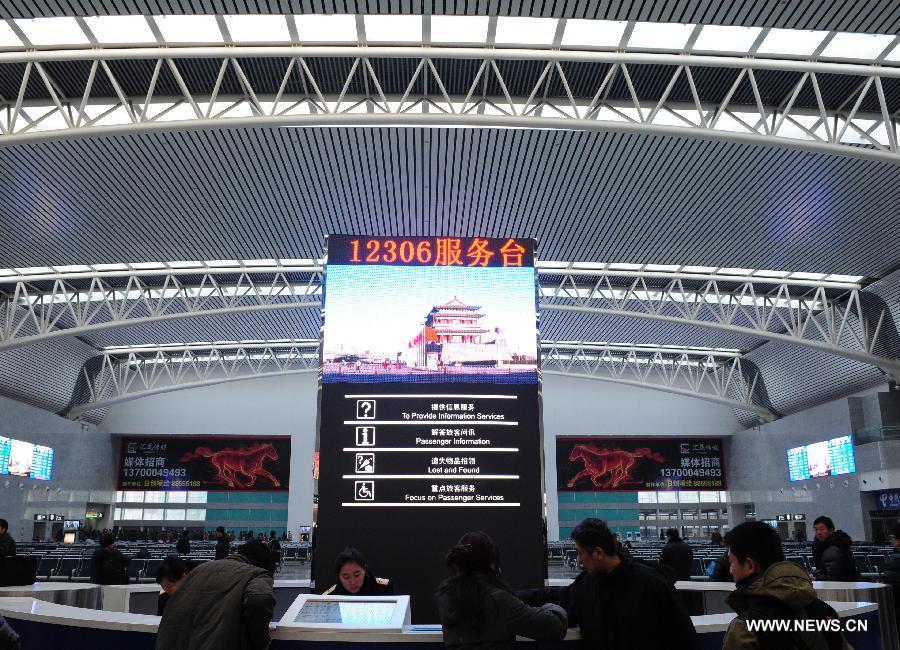 Passengers seek for information at the waiting area for high-speed trains at the Shenyang North Railway Station in Shenyang, capital of northeast China's Liaoning Province, Dec. 1, 2012. The world's first high-speed railway in areas with extremely low temperature, which runs through three provinces in northeastern China, started operation on Saturday. The railway links Harbin, capital of Heilongjiang Province, and Dalian, a port city in Liaoning Province. (Xinhua/Pan Yulong)