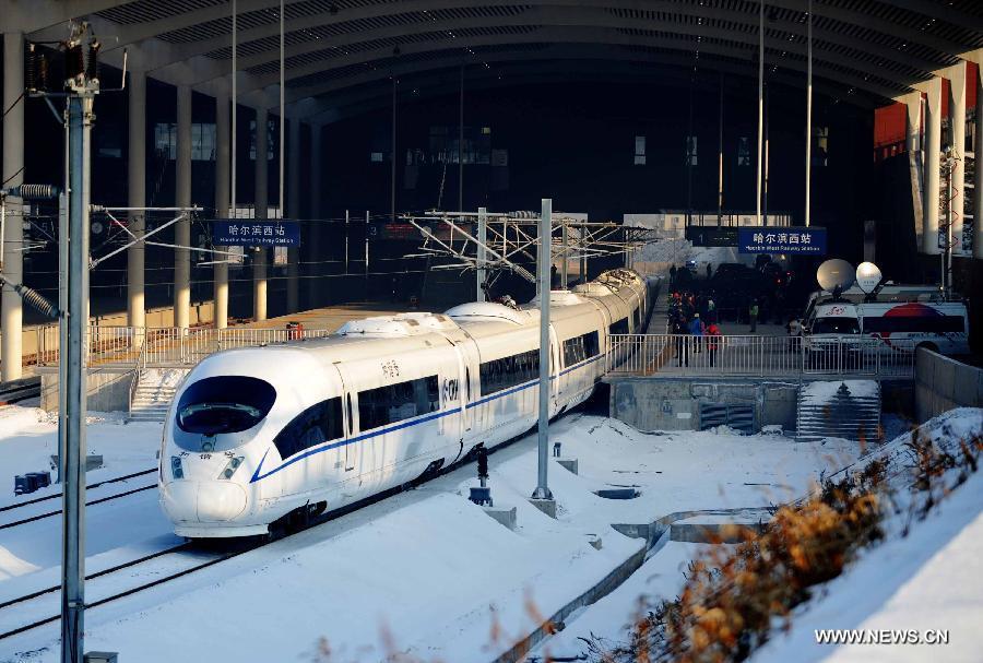 A high-speed train leaves the Harbin West Railway Station in Harbin, capital of northeast China's Heilongjiang Province, Dec. 1, 2012. The world's first high-speed railway in areas with extremely low temperatures, namely the Hada High-speed Railway which runs through the three provinces in northeast China, started operation on Saturday. The railway links Harbin, capital of Heilongjiang Province, and Dalian, a port city in Liaoning Province. (Xinhua/Wang Jianwei)