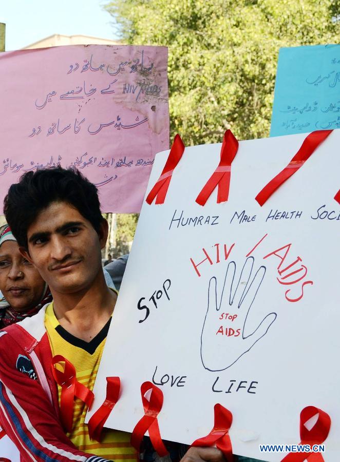 A Pakistani man holds a placarda during a rally to mark the World Aids Day in southern Pakistan's Hyderabad, Dec. 1, 2012. The World AIDS Day which is annually observed on Dec. 1, is dedicated to raising awareness of the AIDS pandemic caused by the spread of HIV infection. (Photo/Xinhua)