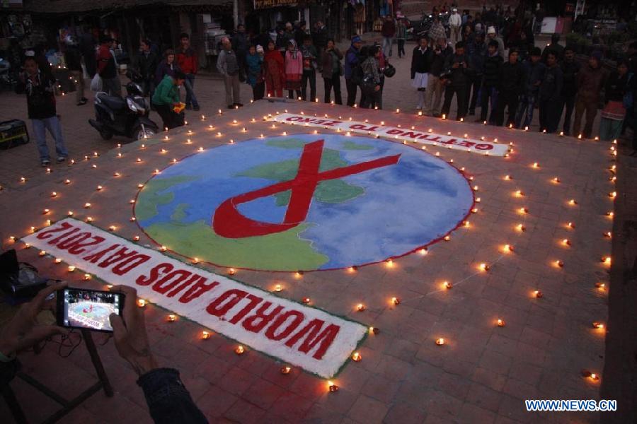 Nepalese make a symbol of red ribbon to mark the World AIDS Day in Kathmandu, Nepal, Dec. 1, 2012. The World AIDS Day which is annually observed on Dec. 1, is dedicated to raising awareness of the AIDS pandemic caused by the spread of HIV infection. (Xinhua/Sunil Pradhan)