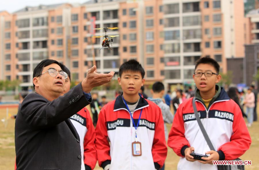 Participants take part in a model aircraft competition for teenagers in Rong'an County, southwest China's Guangxi Zhuang Autonomous Region, Dec. 2, 2012. (Xinhua/Tan Kaixing) 
