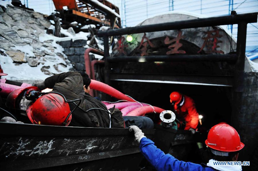 Rescuers work at the head of the flooded mine in Qitaihe City, northeast China's Heilongjiang Province, Dec. 2, 2012. Rescuers on Sunday pulled two miners out alive while 14 others remain trapped after the Furuixiang Coal Mine in Qitaihe City was flooded on Saturday, according to local government sources. (Xinhua/Wang Jianwei) 