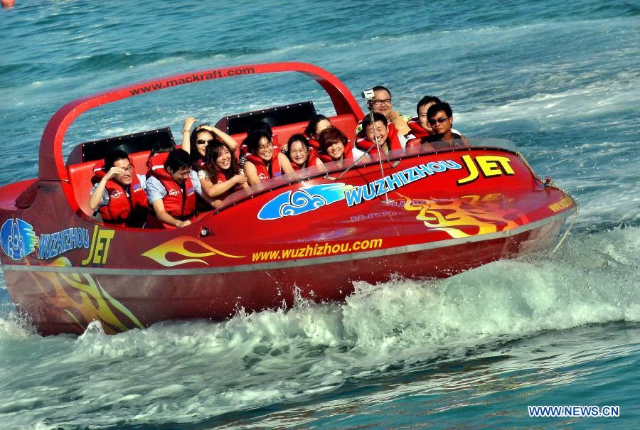 Tourists ride speed boat near Wuzhizhou Island, a scenic spot in Sanya, south China's Hainan Province, Dec. 1, 2012. Sanya has always been a winter tourism preferrence thanks to its tropical climate. (Xinhua/Wang Song) 