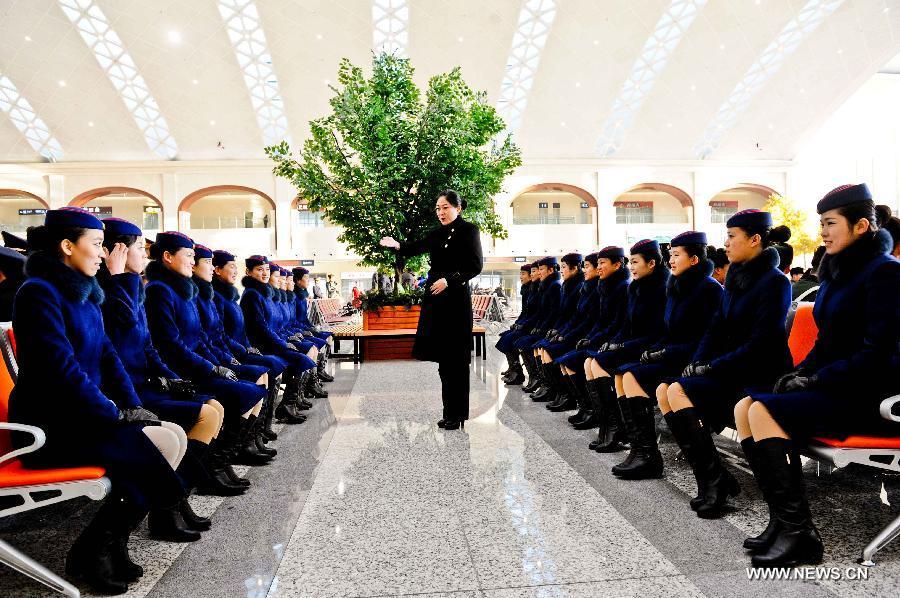 Attendants of a high-speed train make preparations for their work at the Harbin West Railway Station in Harbin, capital of northeast China's Heilongjiang Province, Dec. 1, 2012.  (Xinhua/Wang Song)