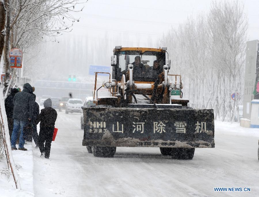 A snow sweeper works amid snowstorm in Shenyang, capital of northeast China's Liaoning Province, Dec. 3, 2012. Liaoning Province issued a red alert for snowstorm on Monday morning, while closing an airport and expressways in the provincial capital of Shenyang. (Xinhua/Li Gang) 
