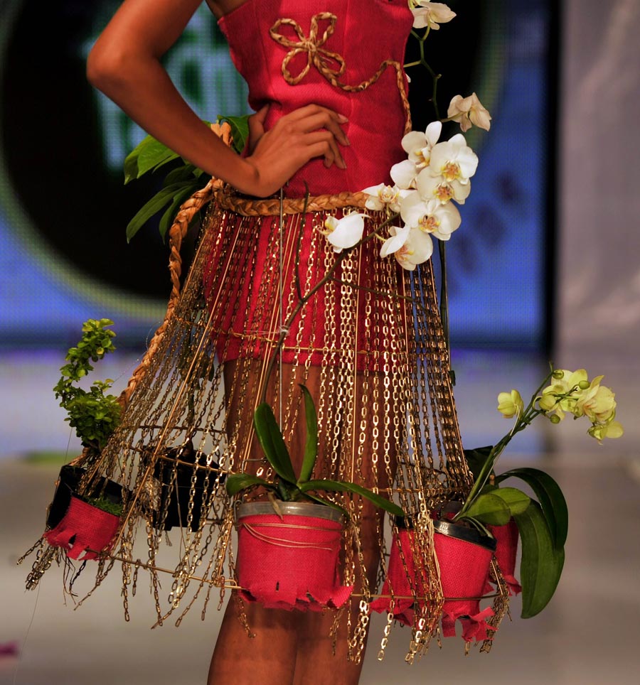 A model shows an ecological outfit made of natural material, the recyclable and plants at an ecological fashion show held in Cali, Columbia, on Dec. 1, 2012. (Xinhua/AFP Photo)