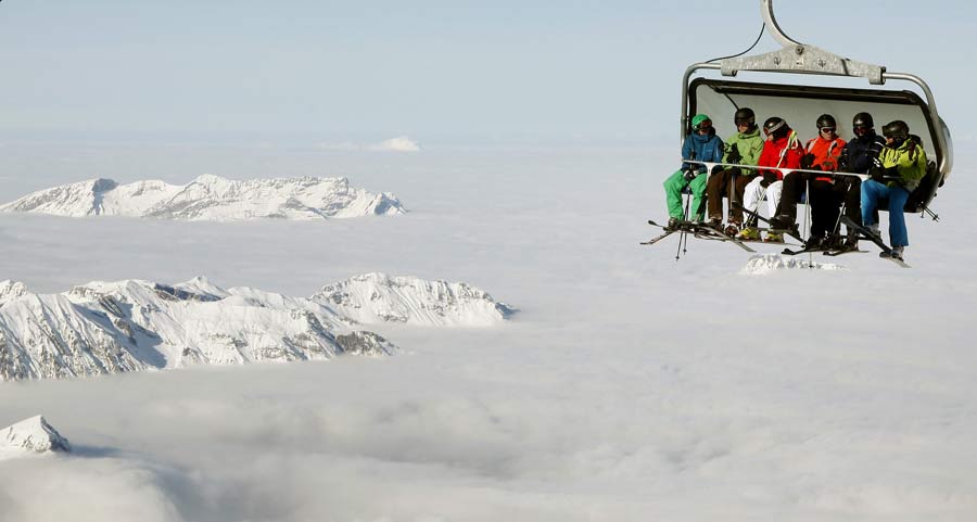 Skiers sit in a chairlift at the Mount Titlis (3,238 m/10,623 ft) skiing area near the Swiss mountain resort of Engelberg December 1, 2012.  (Xinhua/Reuters Photo)