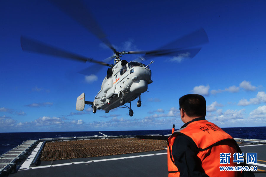 A fleet of the Navy of the Chinese People's Liberation Army (PLA) conducts search and rescue drills with a helicopter, in the western Pacific Ocean on December 1, 2012. (Xinhua/Sun Yanxin)