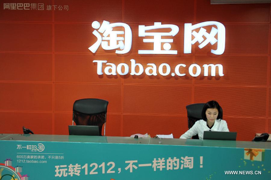 A staff member works at the reception desk of the headquarters of consumer-to-consumer (C2C) online retail website Taobao.com in Hangzhou, capital of east China's Zhejiang Province, Dec. 3, 2012. During a media briefing on Monday, the Alibaba Group, which owns Taobao.com and its business-to-consumer (B2C) counterpart Tmall.com, announced that the transaction volume of the two platforms has reached one trillion RMB (about 161 billion U.S. dollars) by the end of November 2012, ranking after east China's Guangdong, Shandong, Jiangsu and Zhejiang Province in terms of social consumption goods retail volume as compared to the number of 2011.(Xinhua/Huang Zongzhi)