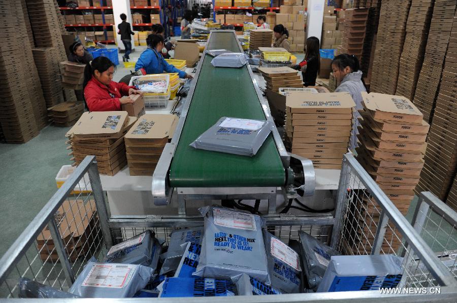 Photo taken on Nov. 11, 2012 shows staff members work at the packing assembly line of online clothing store "Qigege" operated on retail website Tmall.com in Hangzhou, capital of east China's Zhejiang Province. During a media briefing on Dec. 3, 2012, the Alibaba Group, which owns Tmall.com and its consumer-to-consumer (C2C) counterpart Taobao.com, announced that the transaction volume of the two platforms has reached one trillion RMB (about 161 billion U.S. dollars) by the end of November 2012, ranking after east China's Guangdong, Shandong, Jiangsu and Zhejiang Province in terms of social consumption goods retail volume as compared to the number of 2011.(Xinhua/Huang Zongzhi)