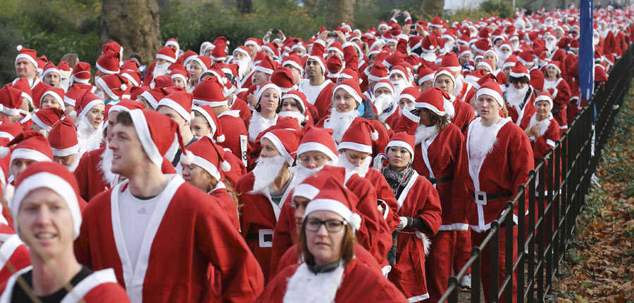 People dresses up as “Santa Claus” to participate in a 6-mile charity run in the Battersea Park in London, Britain, Dec. 1, 2012. (Xinhua/ AFP Photo)