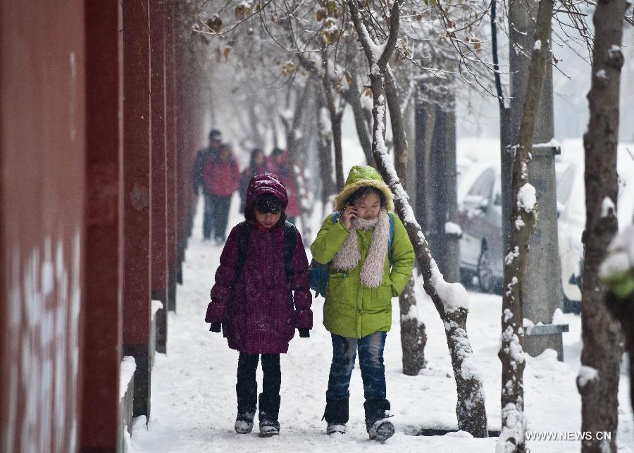 Pupils walk on a snow-covered road in Urumqi, capital of northwest China's Xinjiang Uygur Autonomous Region, Dec. 3, 2012. The city witnessed a snowfall on Monday, where the temperature fell to approximately 14 degrees Celsius below zero. (Xinhua/Wang Fei) 