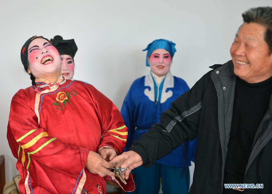 Performers from Xihuangcun Amateur Drama Group share a light moment before a show in Xihuang Village of Zouping County, east China's Shandong Province, Nov. 24, 2012. (Xinhua/Zhu Zheng)