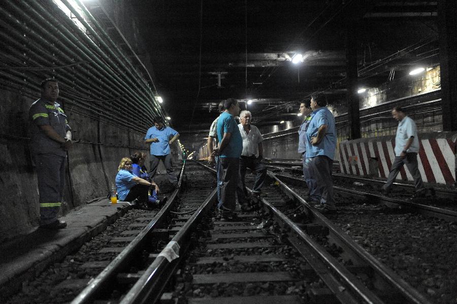 Subway employees remain at Primera Junta station during a strike in Buenos Aires, capital of Argentina, on Dec. 3, 2012. As a result of disputes between union factions, vying for the representation of workers, the Tramway and Motorized Drivers Union (UTA) decreed a total stoppage in the six subway lines and Premetro, according to local press. (Xinhua/Gustavo Amarelle/TELAM) 