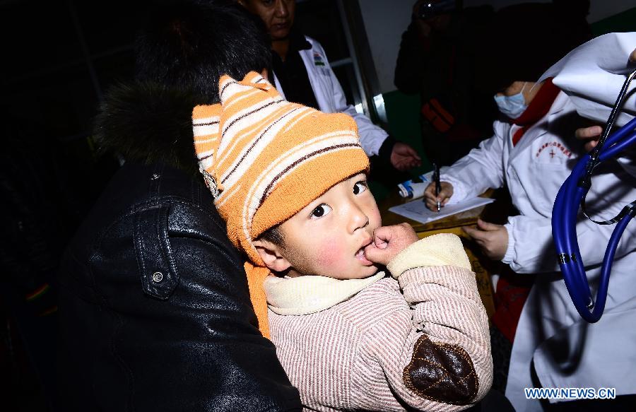 Four-year-old Cering Zhaxi, a child with congenital heart disease, wait to receive medical check by a doctor from Anhui Red Cross Cardiovascular Hospital in Nangqian County, northwest China's Qinghai Province, Dec. 3, 2012. More than 500 children here will receive free heart disease test by doctors from Anhui Red Cross Cardiovascular Hospital and 15 children with congenital heart disease will be treated for free in Hefei, capital of east China's Anhui Province. (Xinhua/Zhang Hongxiang) 