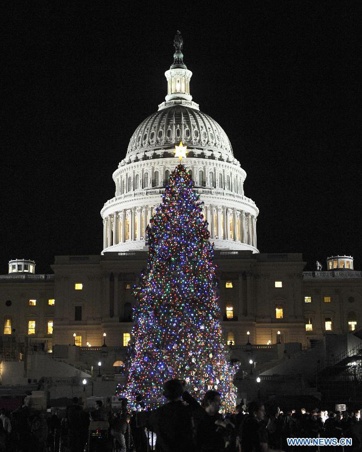 The 2012 Capitol Christmas Tree is lit at the West Front Lawn of the Capitol Hill in Washington D.C., capital of the United States, Dec. 4, 2012. This year's tree, a 65-foot Engelmann spruce, is from the White River National Forest in Colorado. The U.S. Capitol Christmas Tree has been a tradition since 1964. (Photo/Xinhua)