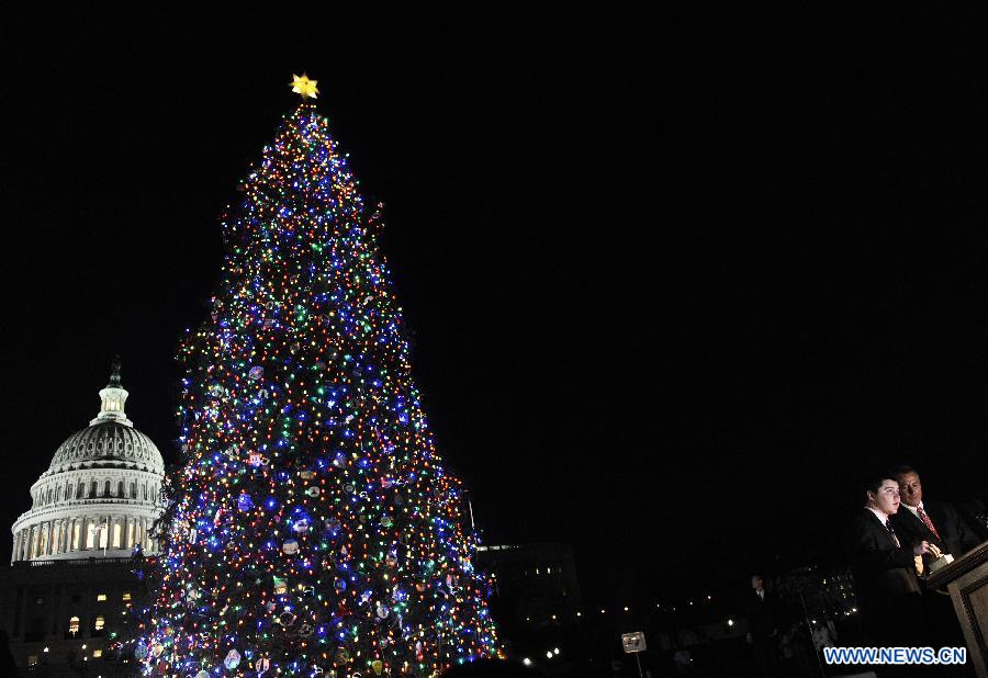 U.S. Speaker of the House John Boehner (1st R) and Ryan Shuster from Colorado Spring, Colorado, light up the 2012 Capitol Christmas Tree at the West Front Lawn of the Capitol Hill in Washington D.C., capital of the United States, Dec. 4, 2012. This year's tree, a 65-foot Engelmann spruce, is from the White River National Forest in Colorado. The U.S. Capitol Christmas Tree has been a tradition since 1964. (Photo/Xinhua)