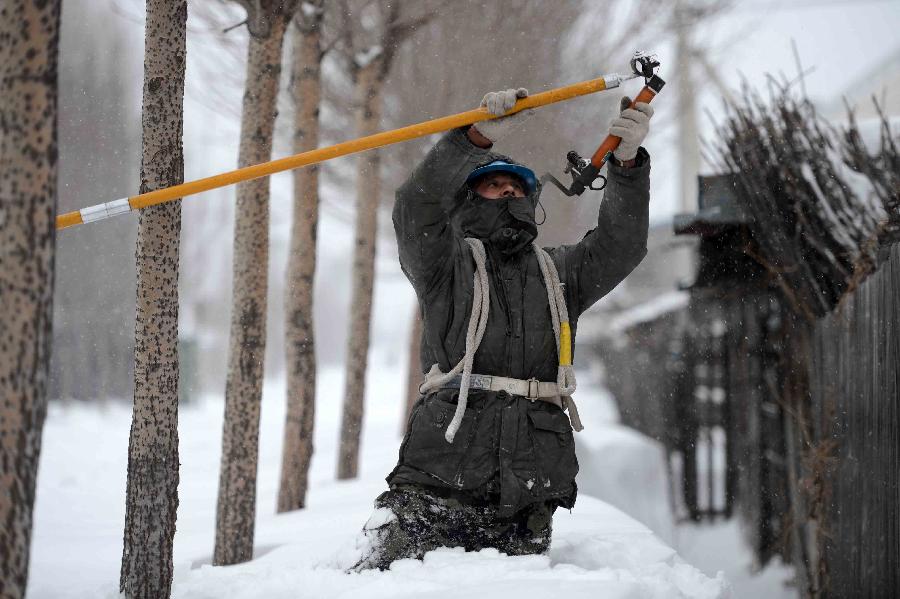 An electrical worker repairs power facility in the snow in Dongfanghong Town, northeast China's Heilongjiang Province, Dec. 4, 2012. The blizzard cut the power supply in many areas in Dongfanghong, disturbing the daily use of electricity for residents and enterprises. (Xinhua/Wang Kai) 