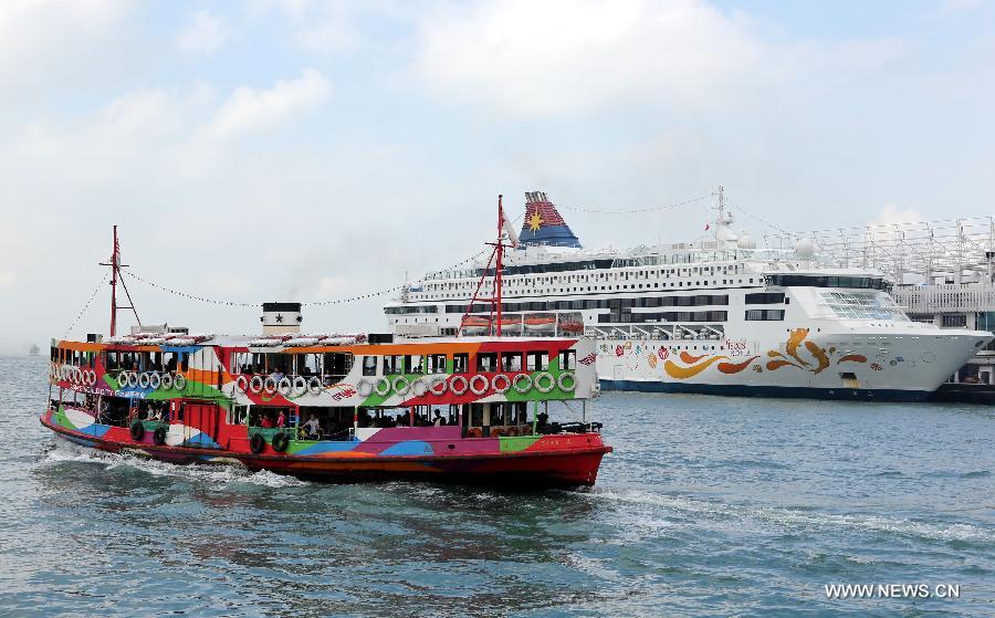 A Star Ferry sails past a cruise liner in Hong Kong, South China, Nov. 10, 2012. Hong Kong ranks first in the ranking list of China city comprehensive competitiveness released by China Institute of City Competitiveness(CICC) on Wednesday. (Xinhua/Li Peng)