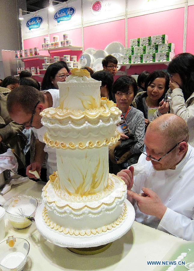 Bakers make a cream cake at the Hong Kong International Bakery Expo in Hong Kong, south China, Dec. 5, 2012. The three-day bakery event kicked off here Wednesday, involving participants from home and abroad. (Xinhua/Zhao Yusi)