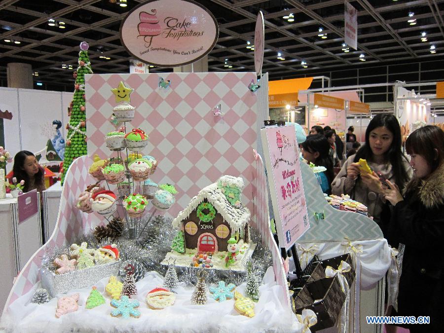 Visitors take photos of cake models exhibited at the Hong Kong International Bakery Expo in Hong Kong, south China, Dec. 5, 2012. The three-day bakery event kicked off here Wednesday, involving participants from home and abroad. (Xinhua/Zhao Yusi)