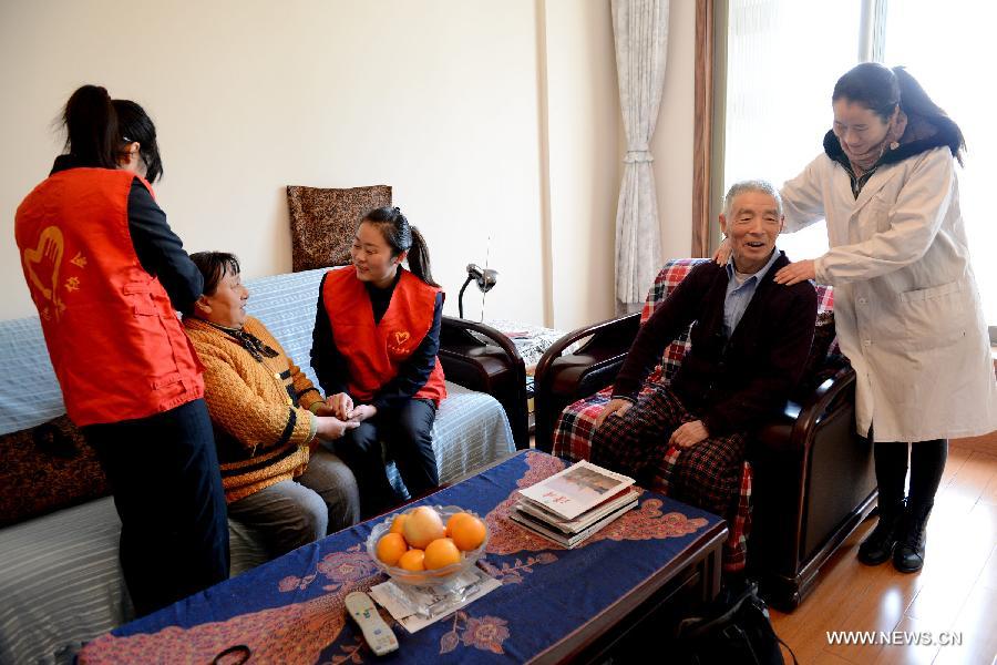 Volunteers chat with elders who have no children living with them in Hefei, capital of east China's Anhui Province, Dec. 5, 2012. Many Chinese volunteers make their contributions to the society on Wednesday, to mark the International Volunteer Day, which is an international observance designated by the United Nations since 1985. (Xinhua/Zhang Duan) 