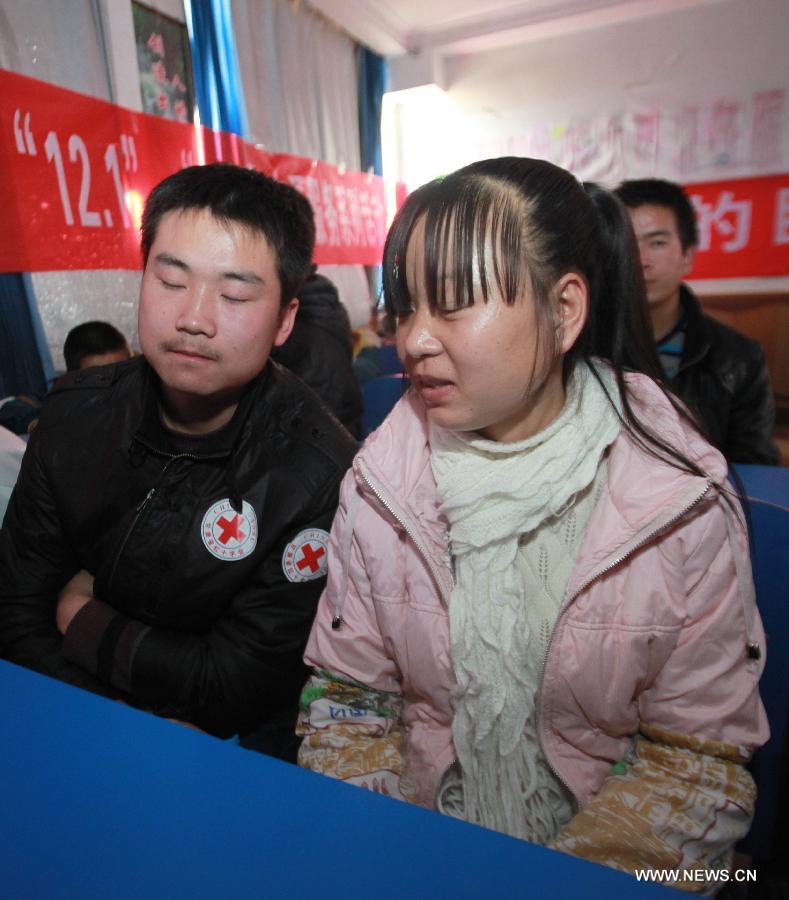 A volunteer (L) from Lanzhou University of Technology has a talk with a blind student at Lanzhou School for the Blind, Deaf and Dumb in Lanzhou, capital of northwest China's Gansu Province, Dec. 4, 2012, a day ahead of the International Volunteer Day. The International Volunteer Day, which falls on Dec. 5 every year, is an international observance designated by the United Nations since 1985. (Xinhua/Huang Wenxin) 
