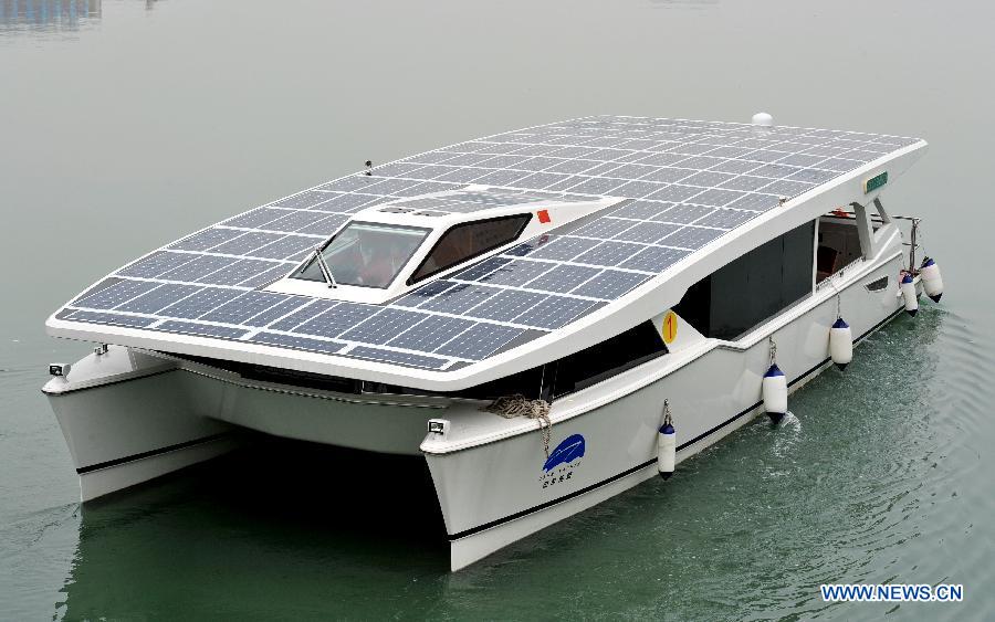 Photo taken on Dec. 5, 2012 shows a solar yacht on the Yundang Lake in Xiamen, southeast China's Fujian Province. The 15-meter-long and 6-meter-wide solar yacht was put into use on Wednesday. The yacht can transform the collected solar energy into electricity to provide power supply for the facilities on board. (Xinhua/Zhang Guojun) 