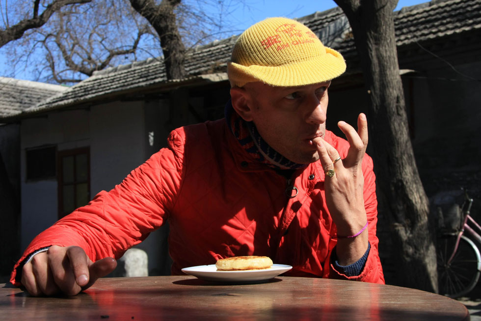 Johnson-Hill has lunch in an alley near Nanluoguxiang of Beijing, capital of China, March 6, 2012.