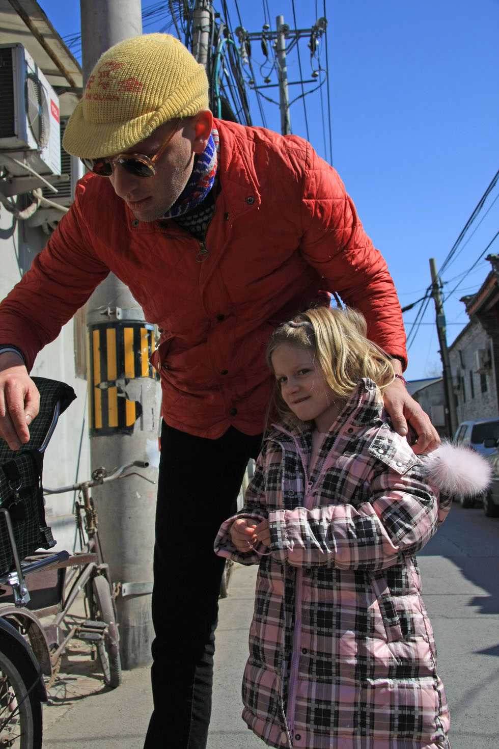 Johnson-Hill greets her daughter after school outside the Fensiting kindergarten in Beijing, capital of China, March 6, 2012.