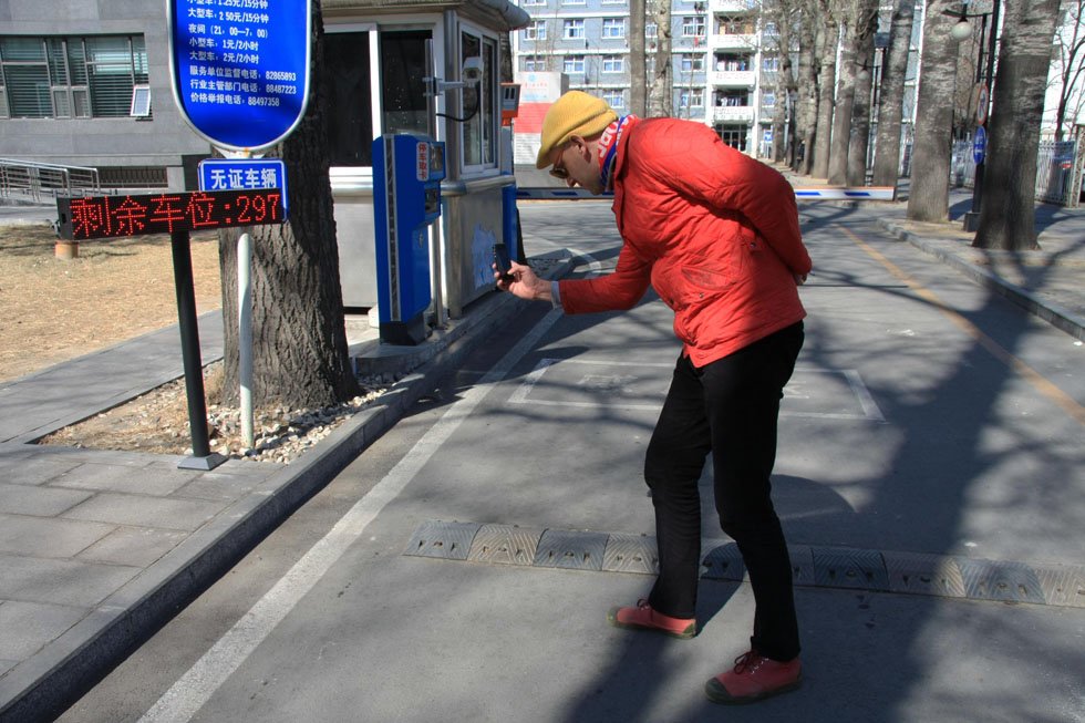 Johnson-Hill takes photo of a parking guiding board in China Youth University of Political Sciences in Beijing, capital of China, March 6, 2012. 