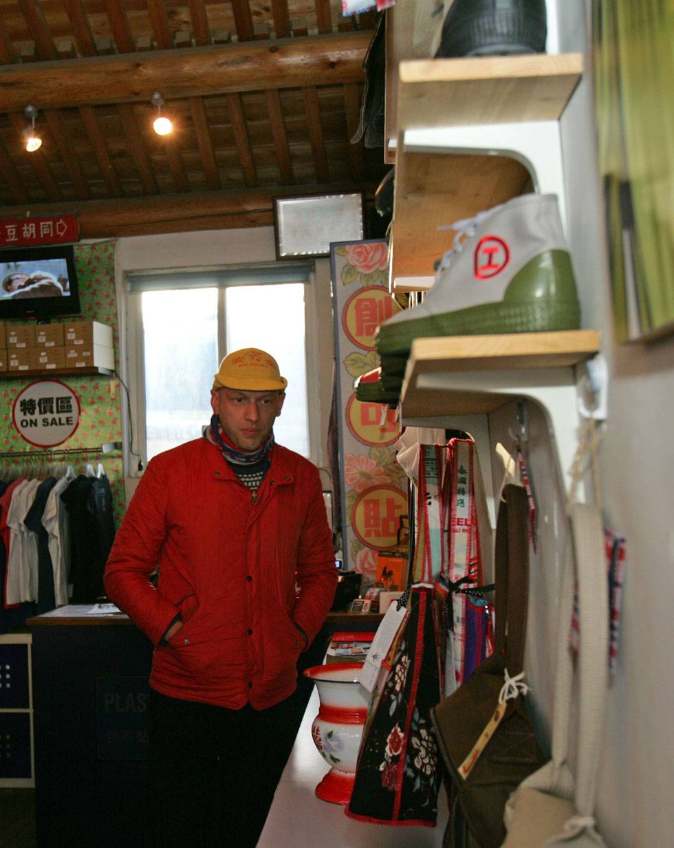 Johnson-Hill is seen at his "Plastered 8" store in Nanluoguxiang of Beijing, capital of China, March 6, 2012. 