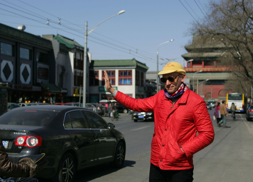 Johnson-Hill takes taxi on a road near Nanluoguxiang of Beijing, capital of China, March 6, 2012. 