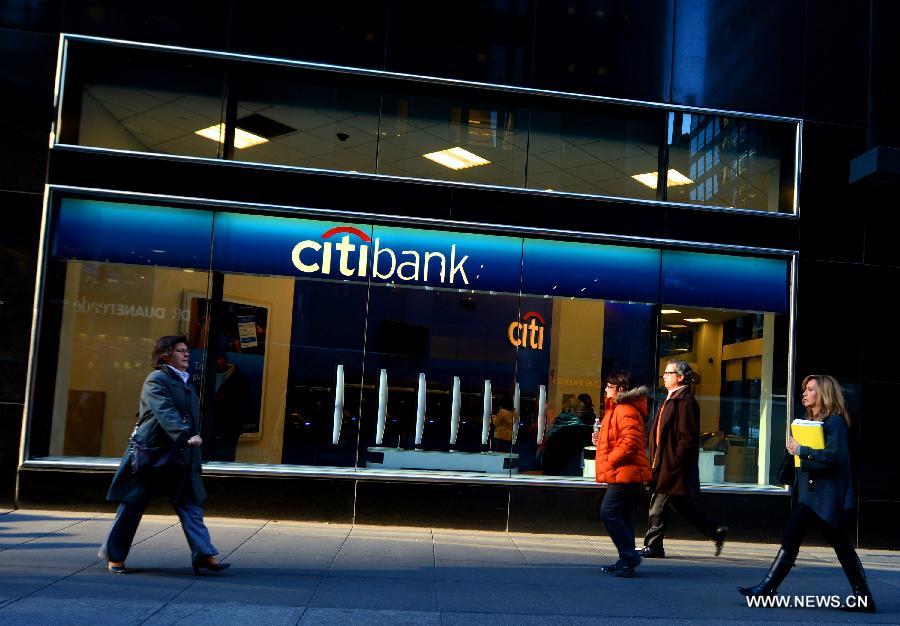 People walk past a Citibank branch in New York, the United States, Dec. 5, 2012. Citigroup announced on Wednesday that it would slash 11,000 jobs, or roughly 4 percent of its current workforce, in an effort to cut costs. (Xinhua/Wang Lei) 