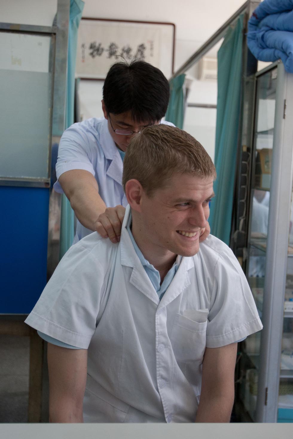 Florian Paillard (front) makes faces as his college Li Jin massages his neck during a work break at the Acupuncture and Moxibustion Hospital of Anhui University of Traditional Chinese Medicine in Hefei, capital of east China's Anhui Province, May 18, 2012.(Xinhua/Liu Junxi)