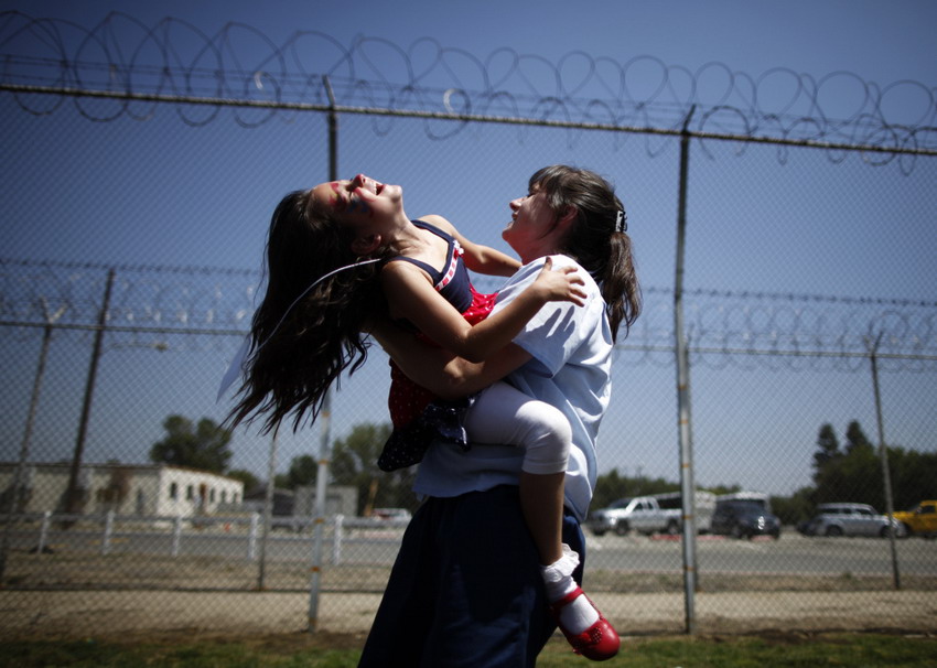 Cori Walter, 32, hugs her daughter Hannah Walter at California women states prison on Mother’s Day on May 5, 2012.(Reuters/Lucy Nicholson)