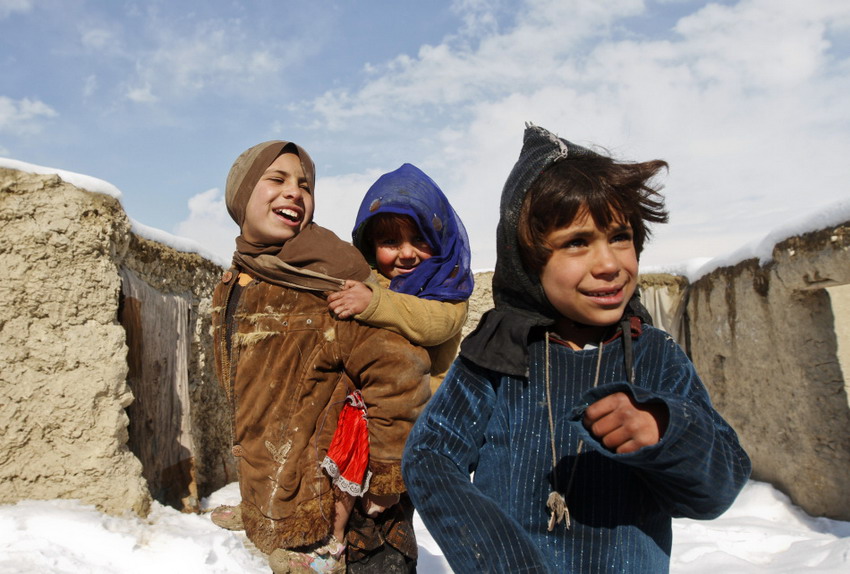 Children who became homeless due to the war stand outside of snow-covered tent in Afghanistan on Feb 5, 2012. (Reuters/Mohammad Ismail)