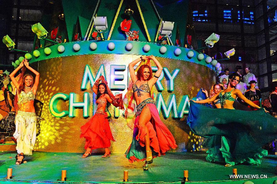 Foreign performers dance during a lighting ceremony celebrating the upcoming Christmas and new year at Shanghai Xintiandi, one of the city's tourist landmarks, in Shanghai, east China, Dec. 5, 2012. (Xinhua/Guo Changyao) 