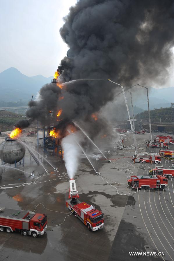 Fire fighters put out a fire during a joint search and rescue exercise in Chongqing, southwest China, Dec. 6, 2012. The joint exercise was held on Thursday to celebrate that the National (Chongqing) Land Search and Rescue Base was officially put into service. (Xinhua/Chen Cheng)