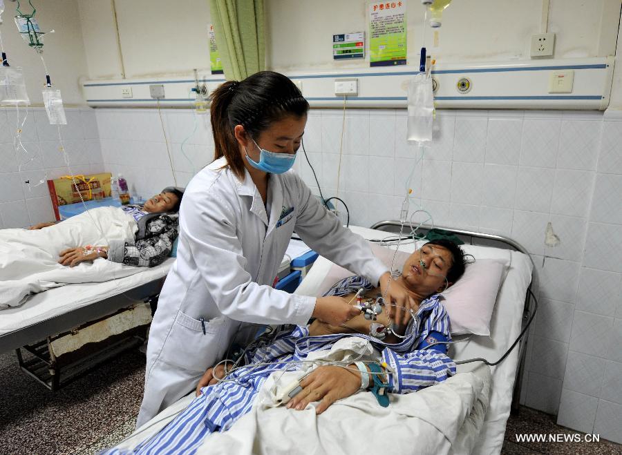 An injured miner receives medical treatment in hospital in Fuyuan County, southwest China's Yunnan Province, Dec. 6, 2012. Seventeen people have been confirmed dead and six others injured in a coal mine accident of coal and gas outburst occurred at the Shangchang Coal Mine in Huangnihe Township of Fuyuan County on Wednesday afternoon. (Xinhua/Lin Yiguang) 