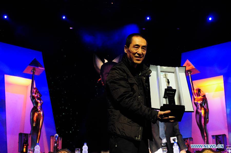Chinese director Zhang Yimou receives a lifetime achievement award during the closing ceremony of the 35th Cairo International Film Festival in Cairo, Egypt, Dec. 6, 2012. (Xinhua/Qin Haishi) 