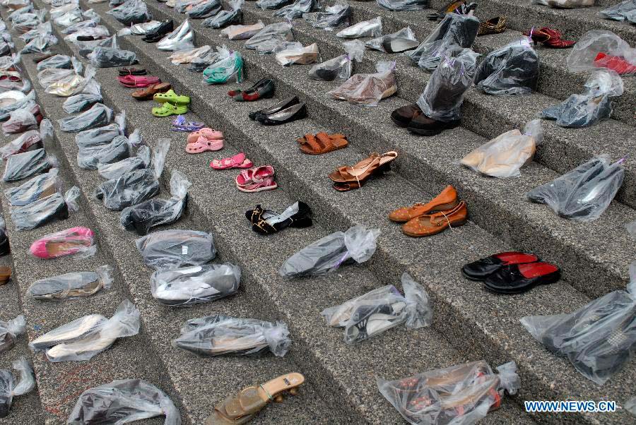 Hundreds of women's shoes cover the steps of Vancouver Art Gallery during annual Shoe Memorial in Vancouver, Canada, Dec. 6, 2012. December 6th is Canada's National Day of Mourning for women who have met with violent deaths. Shoes in bags represent dead women, and those without bags represent women who are alive but suffer from abuse. (Xinhua/Sergei Bachlakov) 