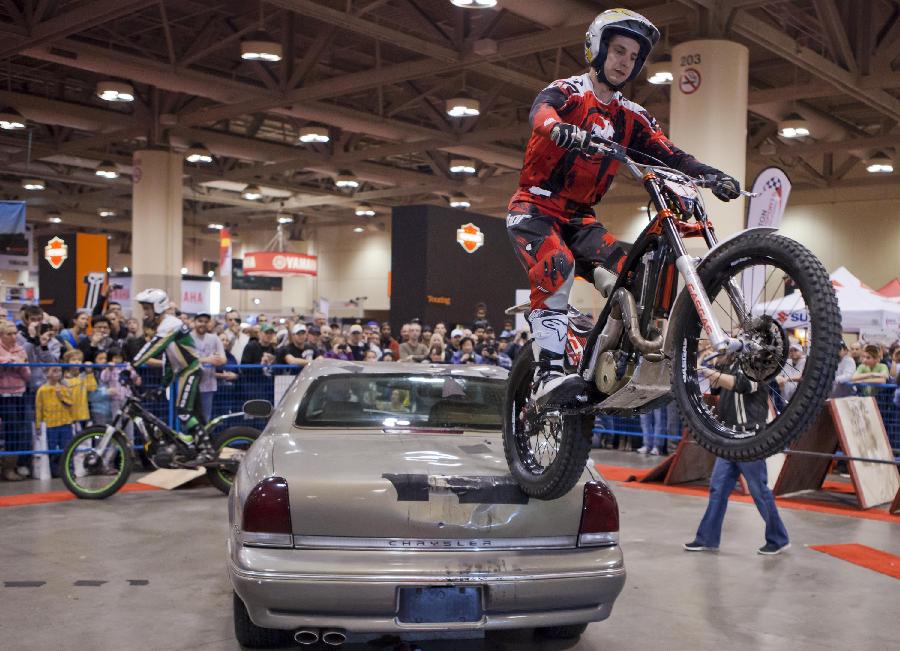 A biker gives a stunt run during the 2012 Toronto Motorcycle Show at the Metro Toronto Convention Centre in Toronto, Canada, Dec. 8, 2012. The three-day event displays hundreds of new 2013 motorcycles, scooters from the world's top manufacturers from Dec. 7 to 9 this year. (Xinhua/Zou Zheng) 