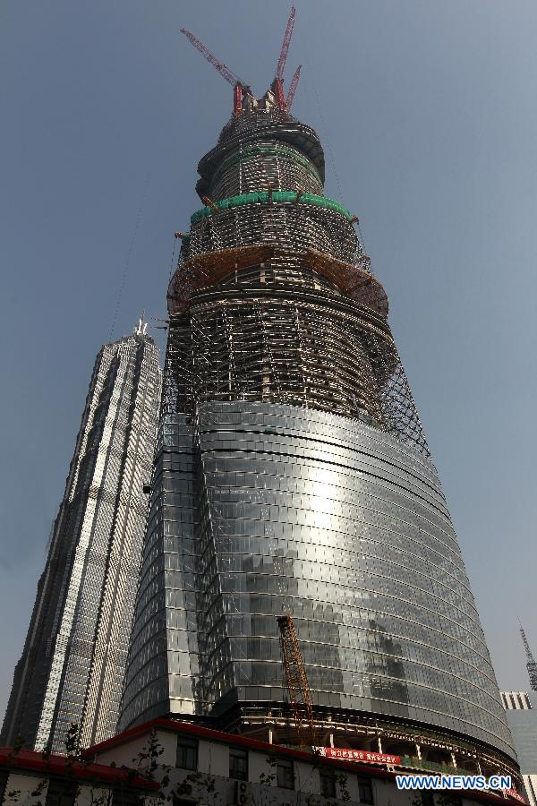 Photo taken on Dec. 8, 2012 shows the Shanghai Tower (R), a skyscraper under construction, and the neighbouring Jin Mao Tower in Pudong, east China's Shanghai Municipality. The Shanghai Tower is expected to reach 632 meters in height and start service in 2015. (Xinhua/Pei Xin) 