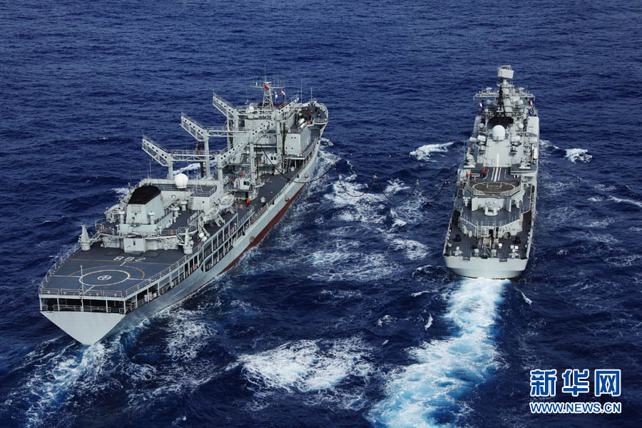 The "Poyang Lake" comprehensive supply ship (L) provides maritime comprehensive supply to the "Ningbo" guided missile frigate(R) on December 6, 2012. (Xinhua/Ju Zhenhua)