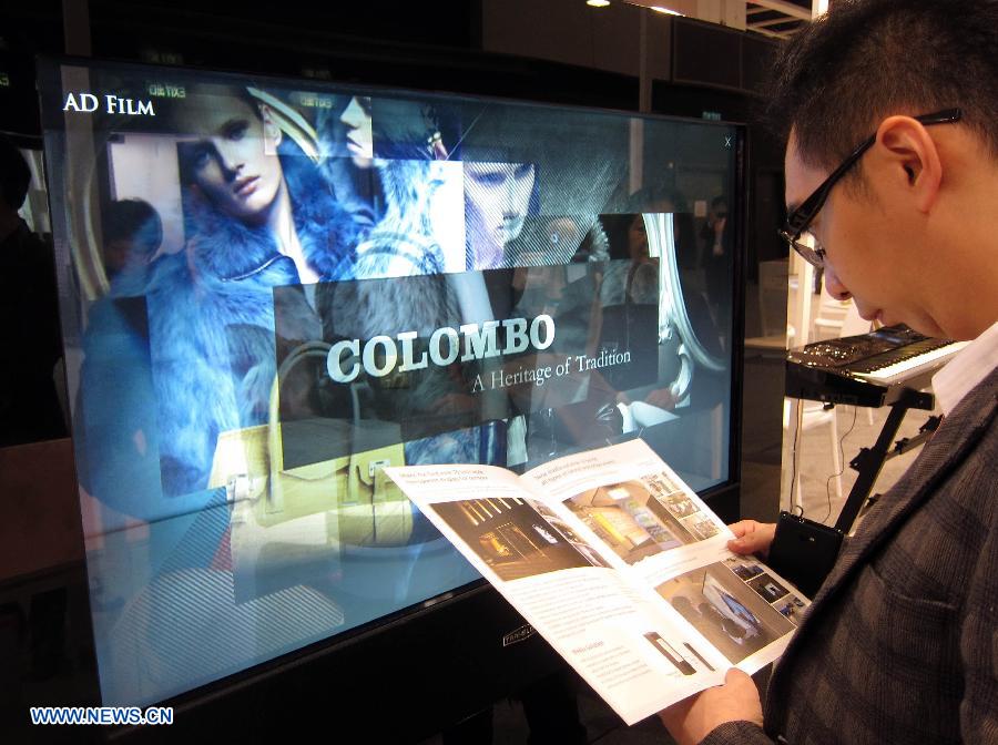 A visitor is pictured in front of a transparent display at the 8th Inno Design Tech Expo in south China's Hong Kong, Dec. 7, 2012. The three-day exposition kicked off Thursday at Hong Kong Convention and Exhibition Center, with more than 350 exhibitors from 11 countries and regions. (Xinhua/Zhao Yusi) 