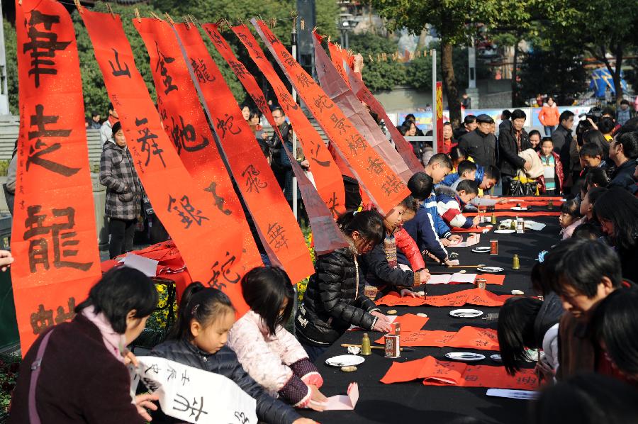 Children write Chinese characters to express their wishes for the New Year in the youth center of Hangzhou, capital of east China's Zhejiang Province, Dec. 9, 2012. In total 30 boys and girls who were the prize winners of the 2nd "Xinmiao" Award of children's calligraphy participated in this activity, works of whom will be sent to welfare agencies like nursing homes. (Xinhua/Ju Huanzong)