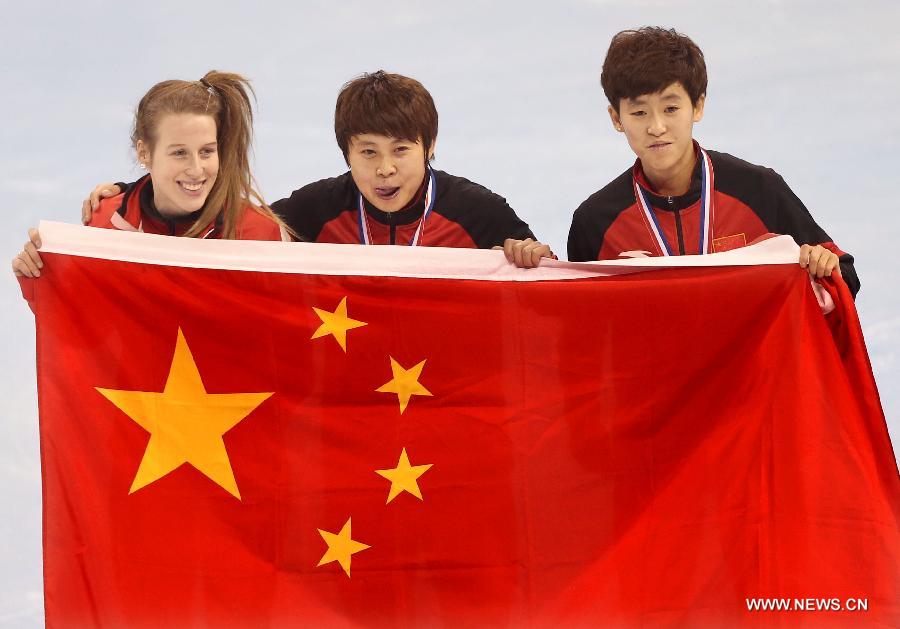 Wang Meng (C) of China and her teammate Fan Kexin (R) celebrate victory during the awarding ceremony of the women's 500m final in the ISU Short Track World Cup speed skating competition in Shanghai, China, on Dec. 9, 2012. Wang won the gold medal with a time of 43.743 seconds.(Xinhua/Fan Jun)