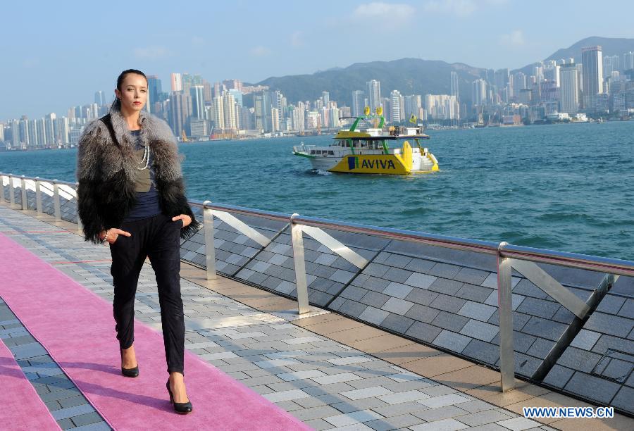 A model is pictured during a catwalk show "The World's Greatest Catwalk" in Victoria Harbour waterfront of Tsim Sha Tsui promenade, south China's Hong Kong, Dec. 9, 2012. The World's Greatest Catwalk 2012 broke the Guinness World Record of the world's longest catwalk on Sunday by having more than 340 models walking on a three kilometers long catwalk. (Xinhua/Zhao Yusi) 