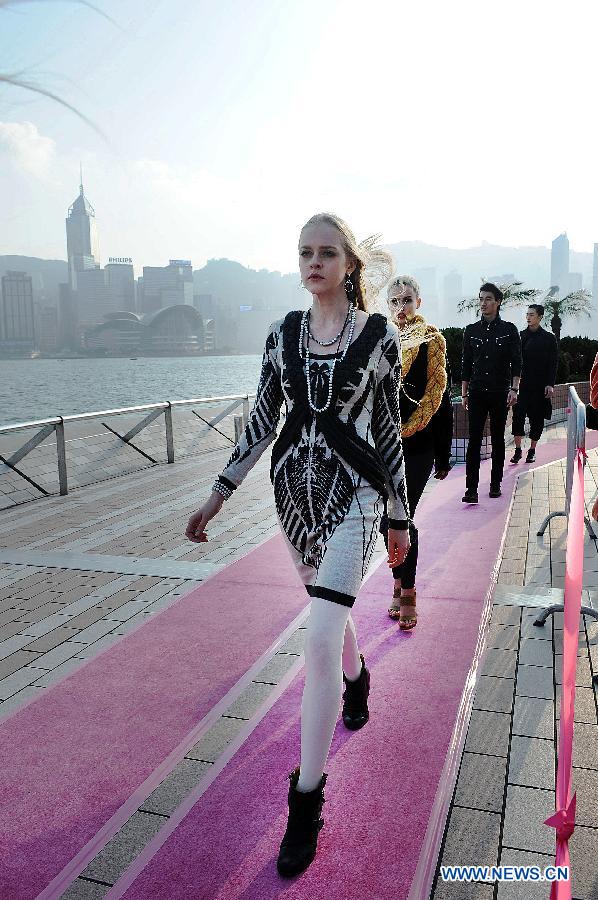 Models are pictured during a catwalk show "The World's Greatest Catwalk" in Victoria Harbour waterfront of Tsim Sha Tsui promenade, south China's Hong Kong, Dec. 9, 2012. The World's Greatest Catwalk 2012 broke the Guinness World Record of the world's longest catwalk on Sunday by having more than 340 models walking on a three kilometers long catwalk. (Xinhua/Zhao Yusi) 
